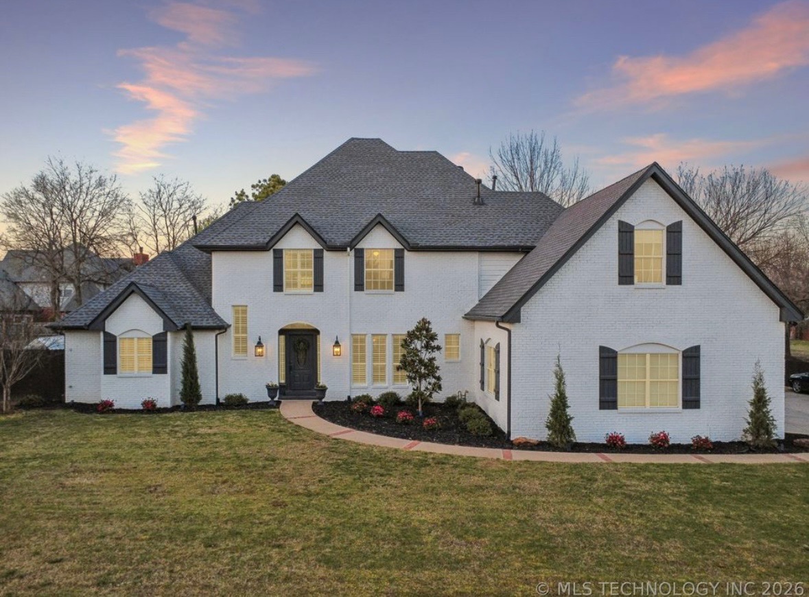 Sold: white-brick estate at sunset