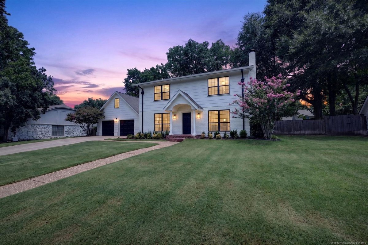 Pending: white two-story colonial at dusk